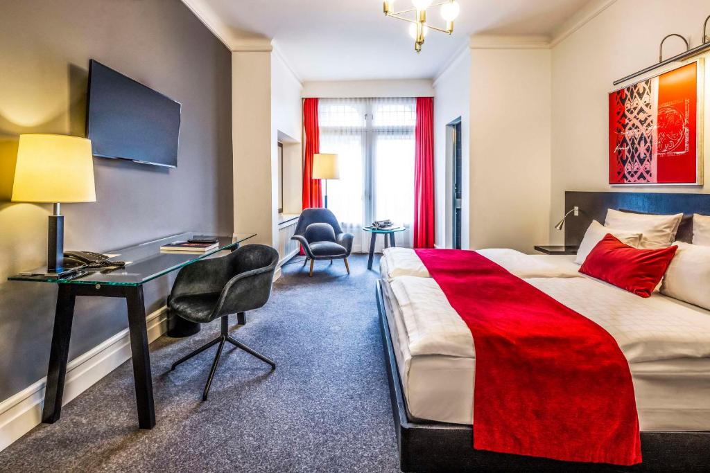a hotel room with a bed and a desk at Scandic Palace Hotel in Copenhagen