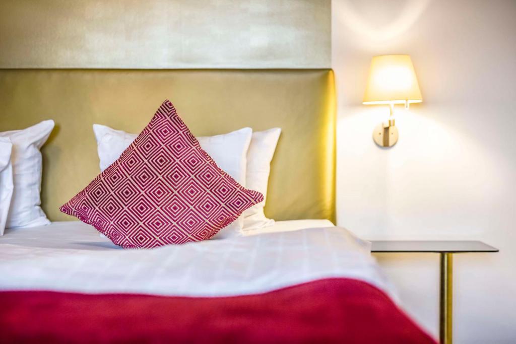 a bed with two pink pillows on top of it at Scandic Palace Hotel in Copenhagen