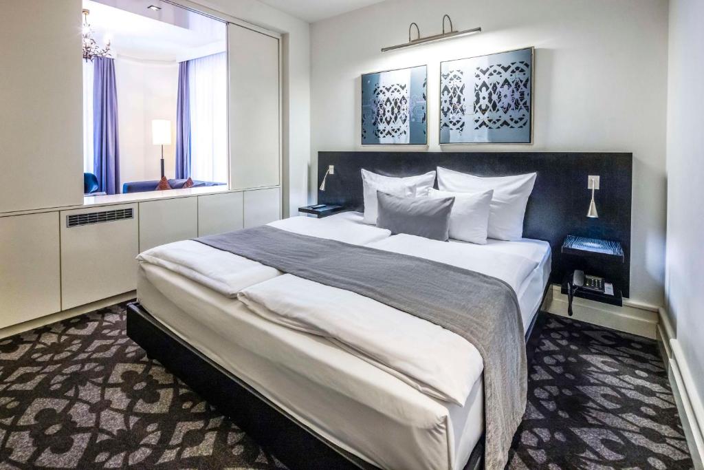 a bedroom with a large white bed in a room at Scandic Palace Hotel in Copenhagen