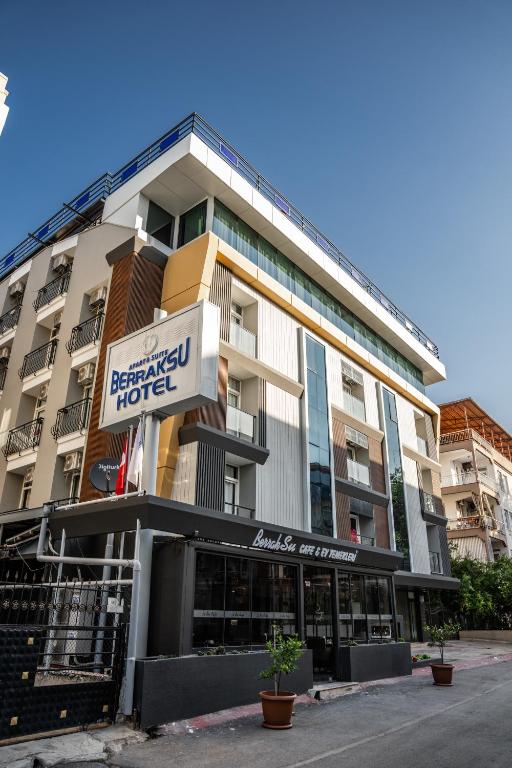 a building with a sign for a hotel at Berrak Su Hotel in Antalya