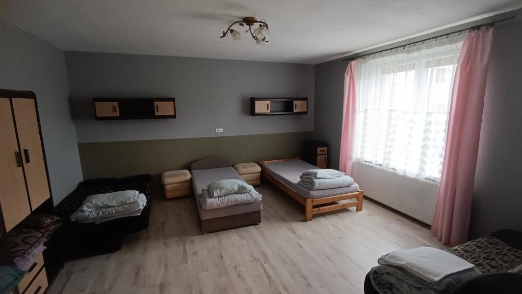 a living room with a couch and a window at Parkowe Ranczo in Poraj