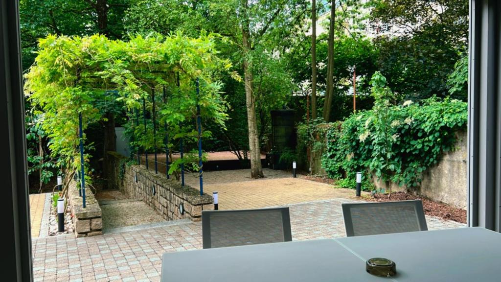 a view of a garden from a window at Domus Hotel in Luxembourg