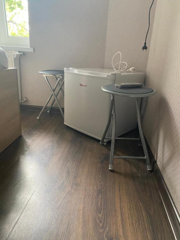 a room with two tables and a refrigerator at #8 Apartments in Odesa
