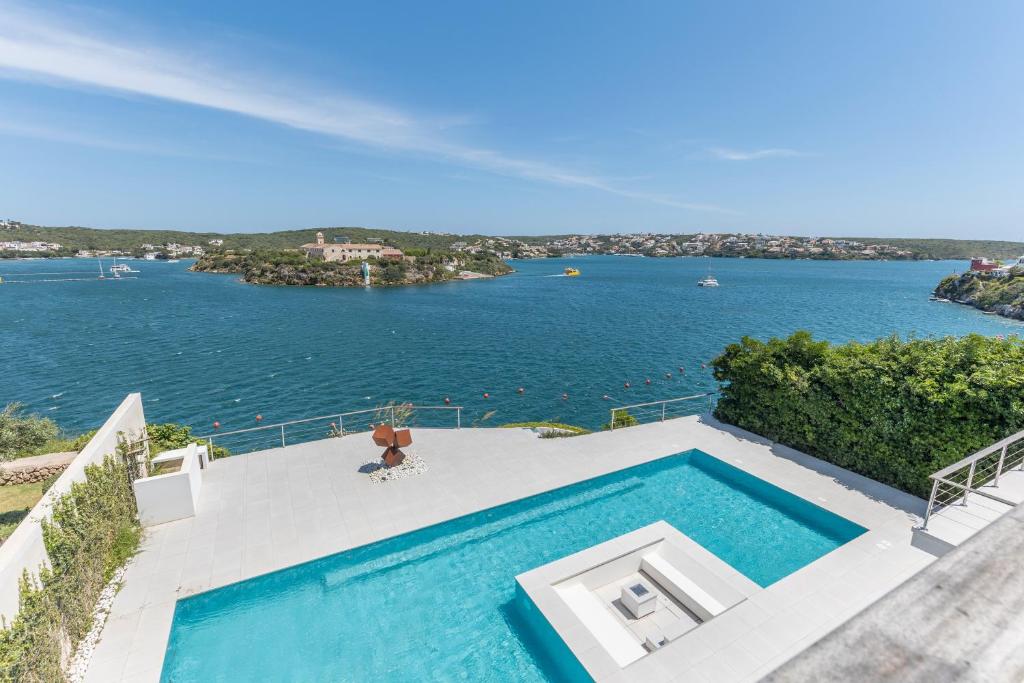 a swimming pool with a view of the water at Hastinapura, acceso directo al mar in Es Castell
