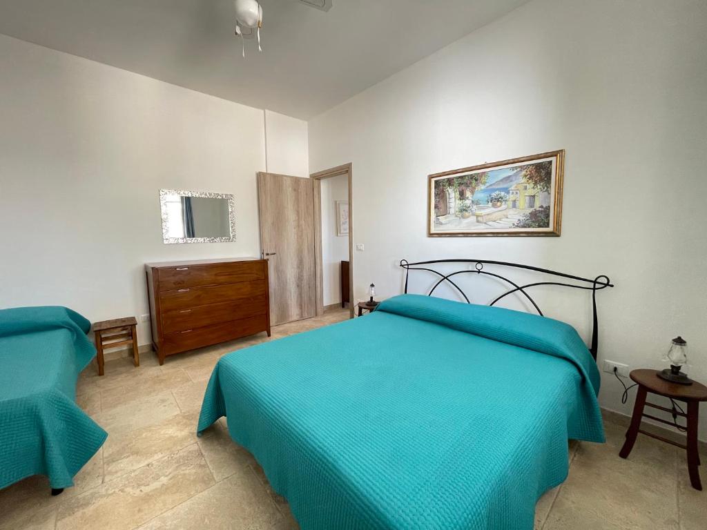 Postel nebo postele na pokoji v ubytování CASA ELAIO - immersa negli ulivi con vista sul mare Ionio