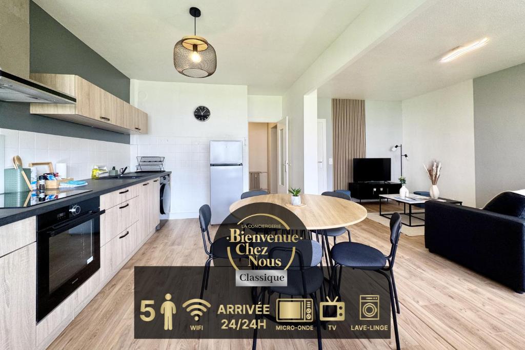 a kitchen and living room with a table and chairs at Chamalières Appartement moderne pour 5 personnes in Chamalières