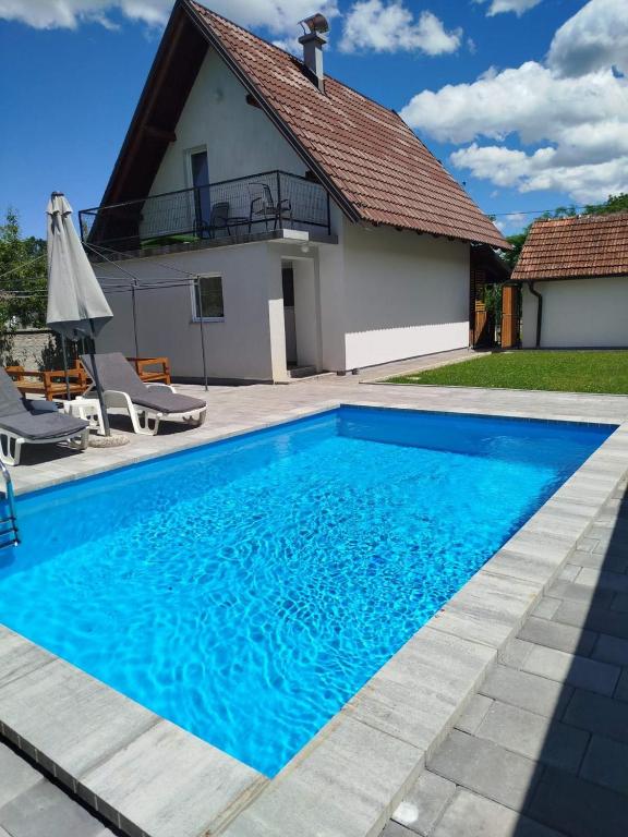 a swimming pool in front of a house at Kuća za odmor Noah in Bihać