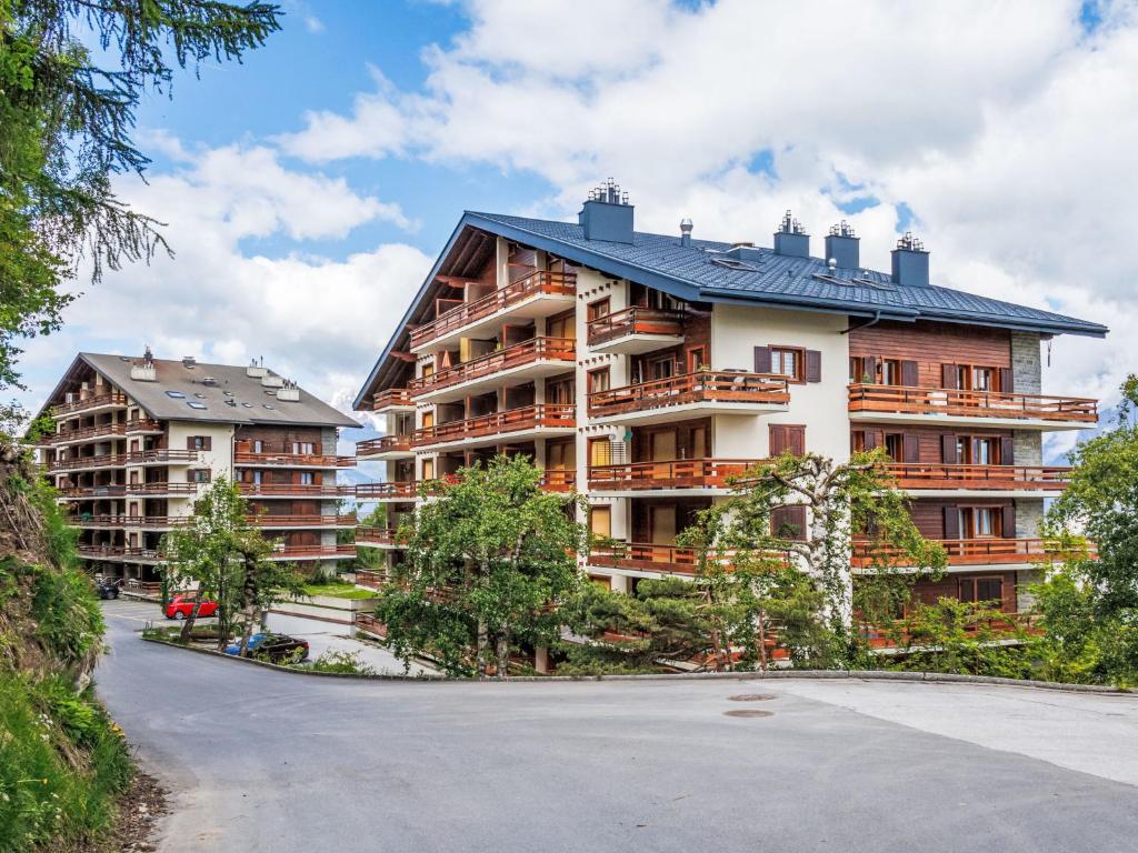 a large apartment building with a black roof at Apartment Derborence 25 by Interhome in Nendaz