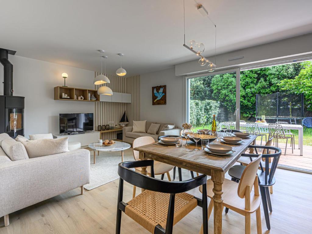 une salle à manger et un salon avec une table et des chaises dans l'établissement Holiday Home Les Marines by Interhome, à Carnac-Plage