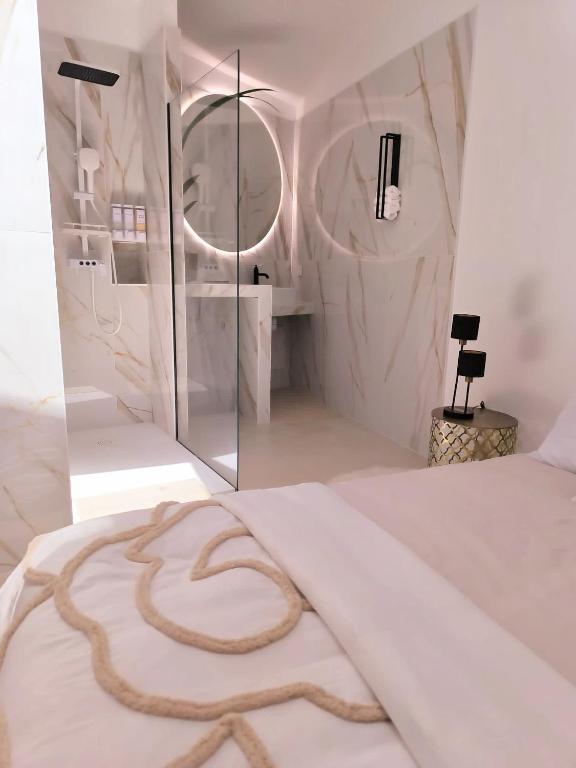 a bedroom with a large white bed with a snake on it at Villa MOOJŸ in Carcès