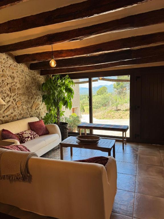 a living room with a couch and a table at Refugi de l'Albera in Vilamaniscle