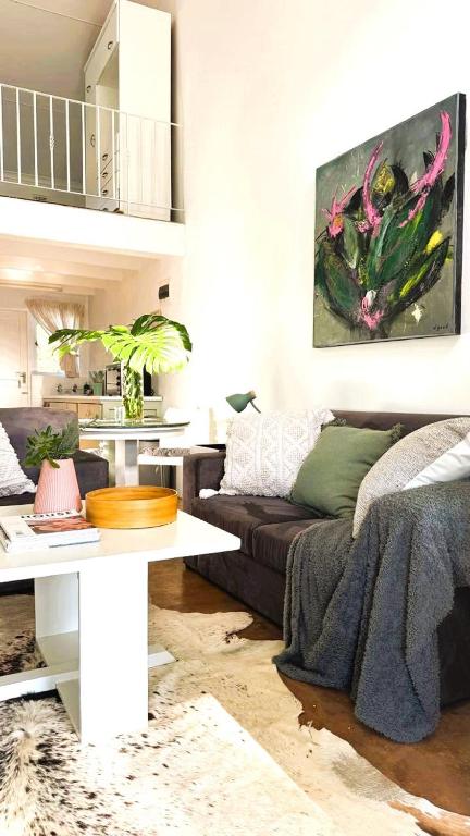 a living room with a couch and a table at Anamcara Villa 3, Natal Midlands Balgowan in Balgowan