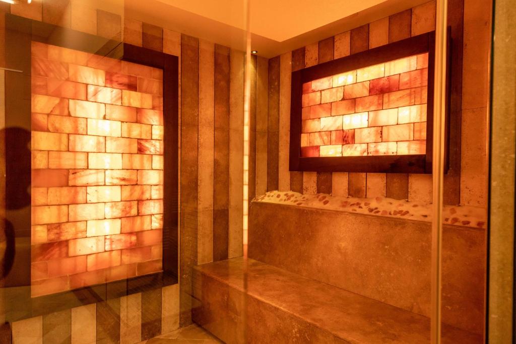 a bathroom with a walk in shower with a glass door at AH Premium Baia dei Faraglioni in Mattinata