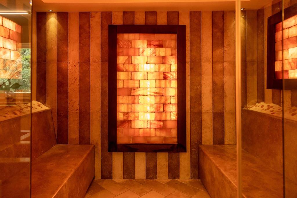 a bathroom with a shower and a fireplace at AH Premium Baia dei Faraglioni in Mattinata