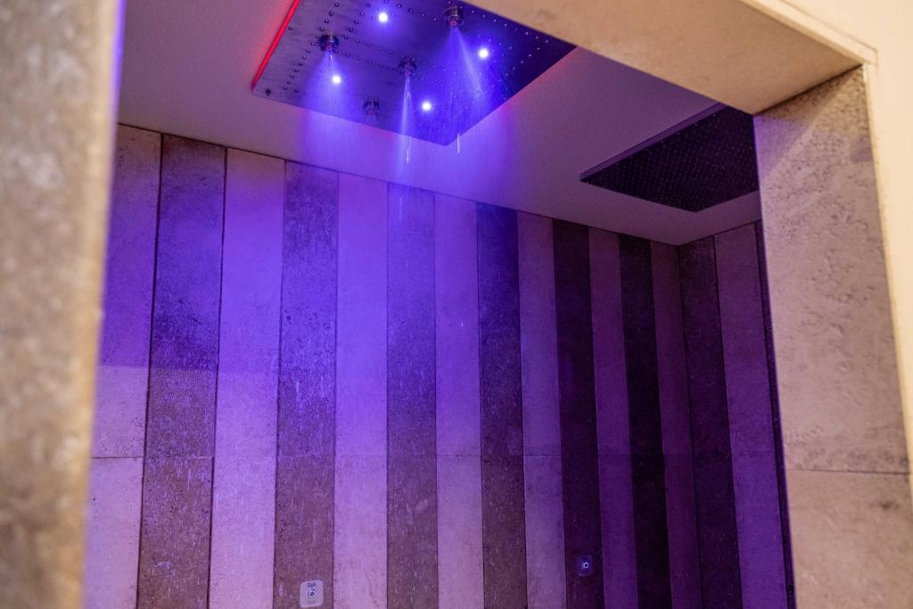 a room with purple lights on the wall at AH Premium Baia dei Faraglioni in Mattinata