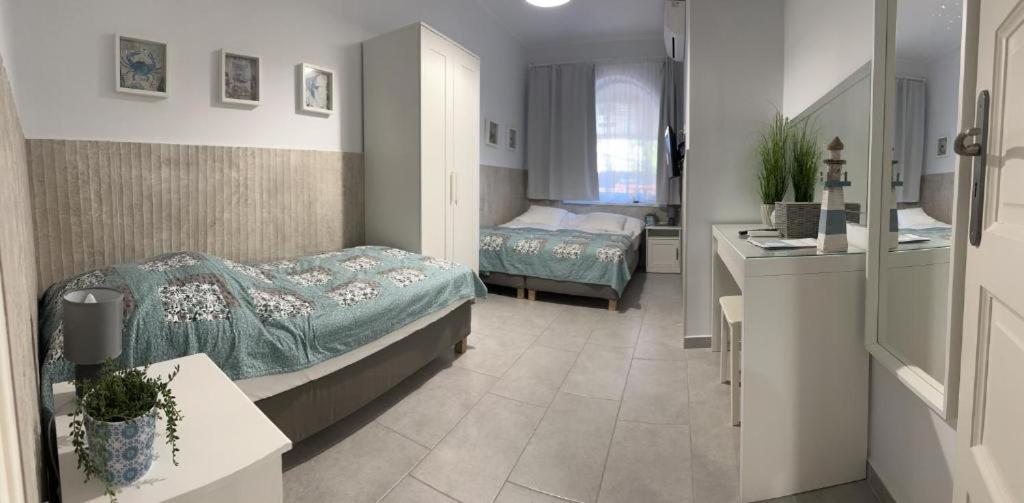 Posteľ alebo postele v izbe v ubytovaní TópART Apartman I