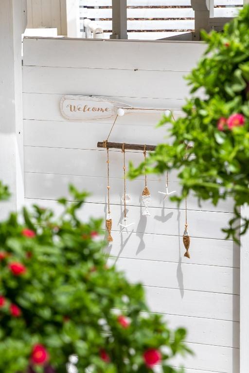 a string of bells hanging on a white wall at AH Premium Baia dei Faraglioni in Mattinata