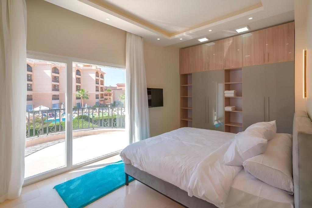 a bedroom with a large bed and a large window at Selena Bay Boutique Hotel in Hurghada