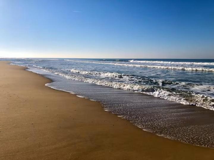 a beach with the ocean and the shoreline at Villa Ibisa in Angles