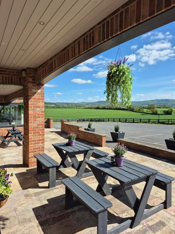 a group of picnic tables on a patio at The White Horse Lodge Hotel in Thirsk