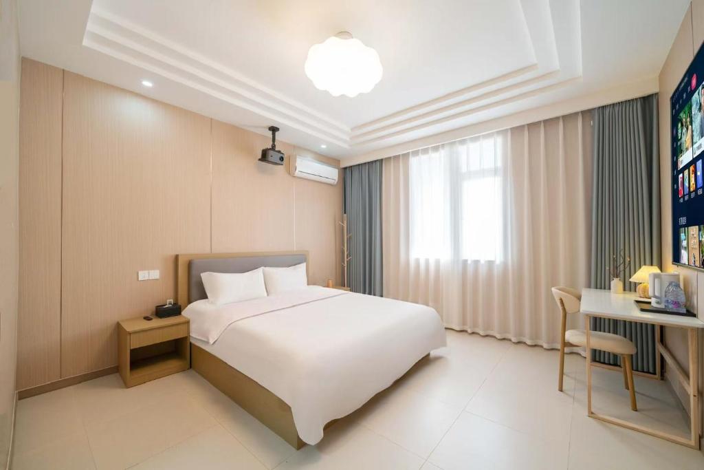 Postel nebo postele na pokoji v ubytování Shanghai nanfeng hotel-上海楠枫花园酒店