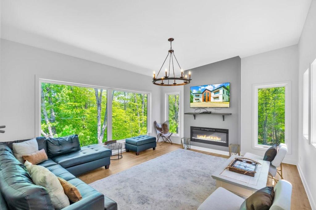 a living room with a couch and a fireplace at Wellness Retreat in the Tremblant Area in La Conception