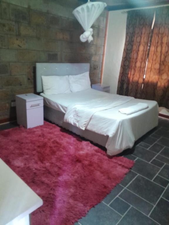 Una cama o camas en una habitación de Global Crib