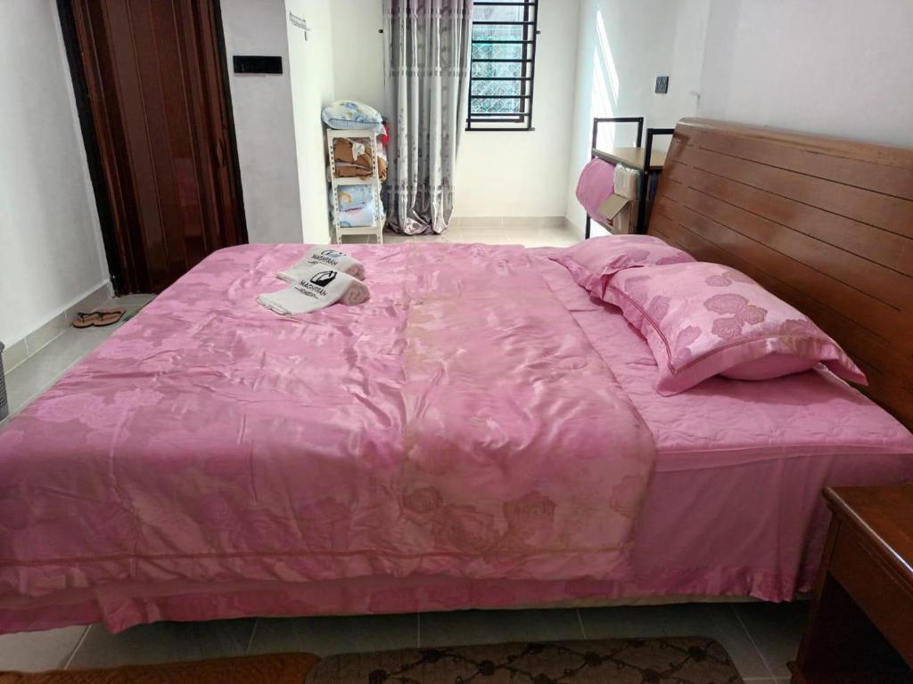 Ένα ή περισσότερα κρεβάτια σε δωμάτιο στο Maghfirah Homestay Langkawi