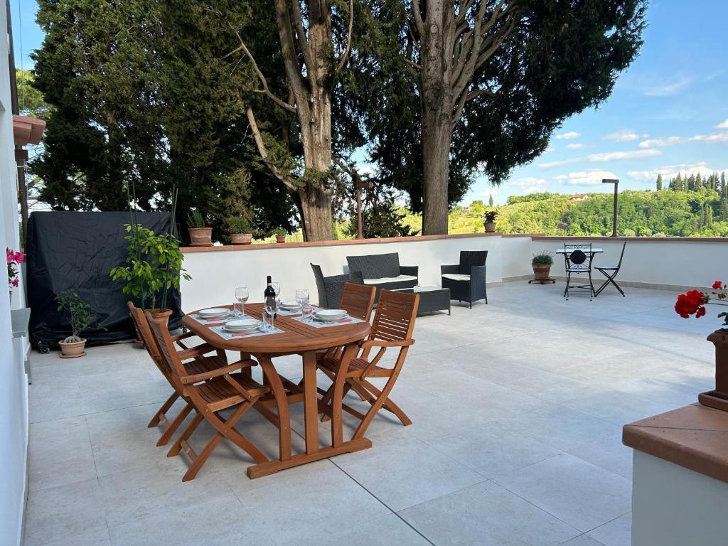a wooden table and chairs on a patio at La Casa di Nena - San Miniato in San Miniato