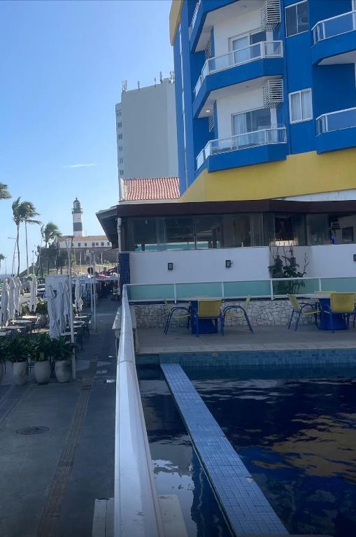 a building with a swimming pool next to a building at BAHIA FLAT Apt 222 in Salvador