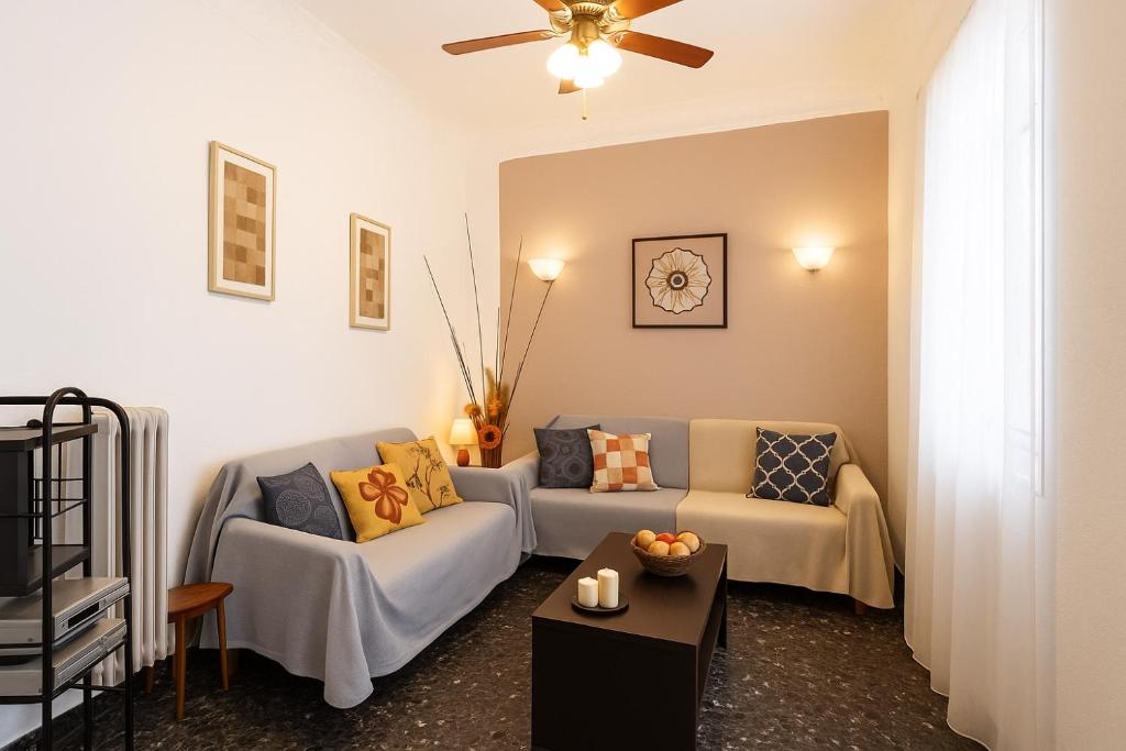 a living room with two couches and a table at Sofi's Flat in the city center, 5min to the sea in Kalamata