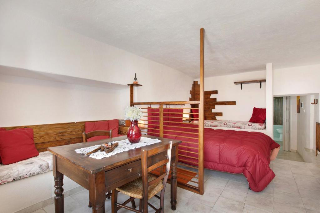a bedroom with a bed and a table and a bed at Nel Cuore della Via Francigena in Aosta