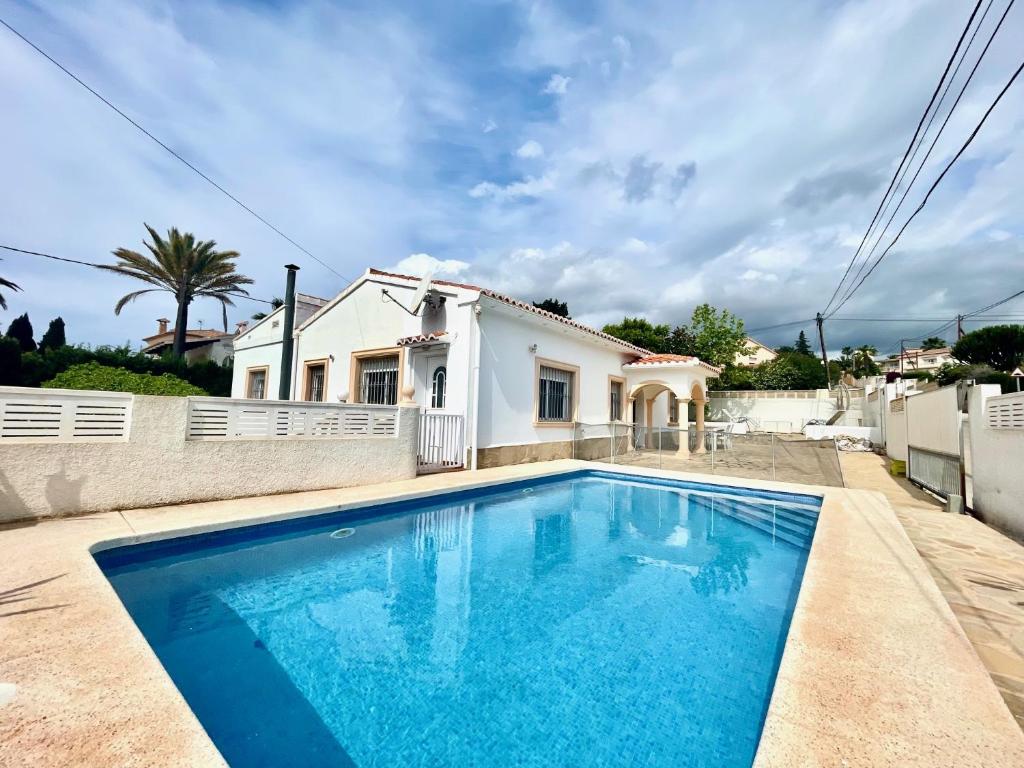 a swimming pool in front of a house at Casa Claudia in Calpe