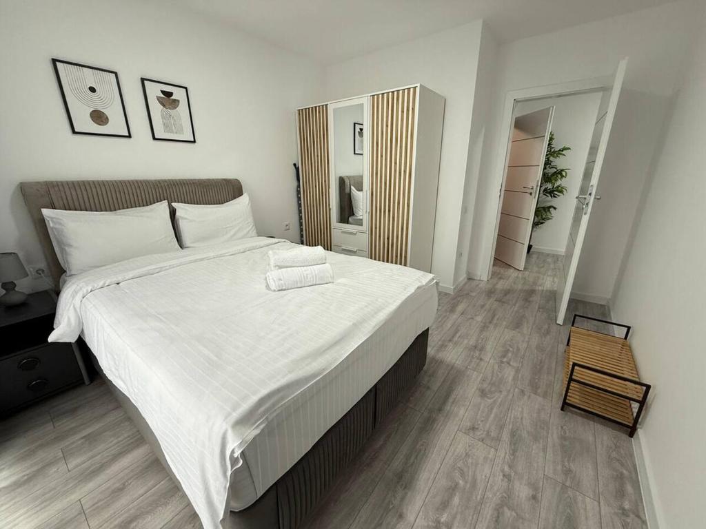 a bedroom with a large bed with white sheets at Serenity retreats VRT in Şelimbăr