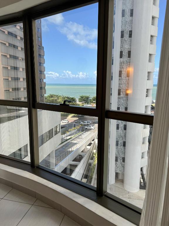 a window view of the ocean from a hotel room at Luxo na Beira Mar - Beach Class Executive 105 in Recife