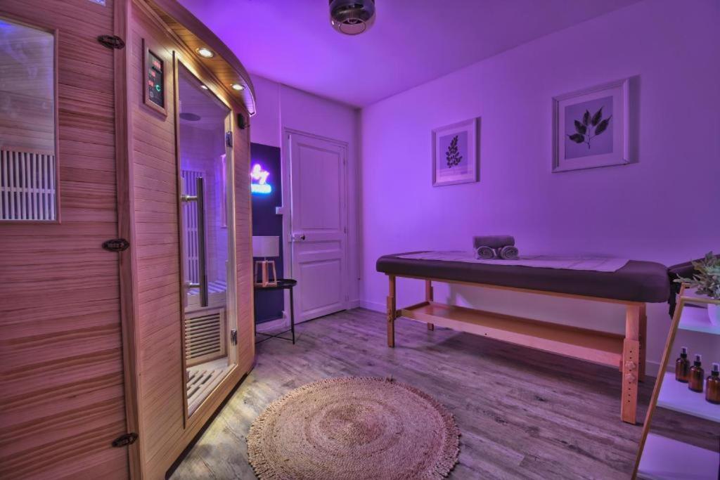 a room with a purple room with a bed in it at Au Sauna de Maintenon in Maintenon