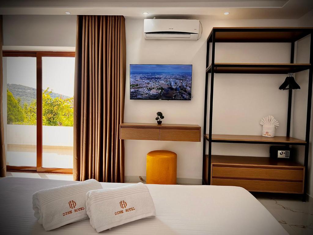 a hotel room with a bed and a window at Dine Hotel in Ksamil