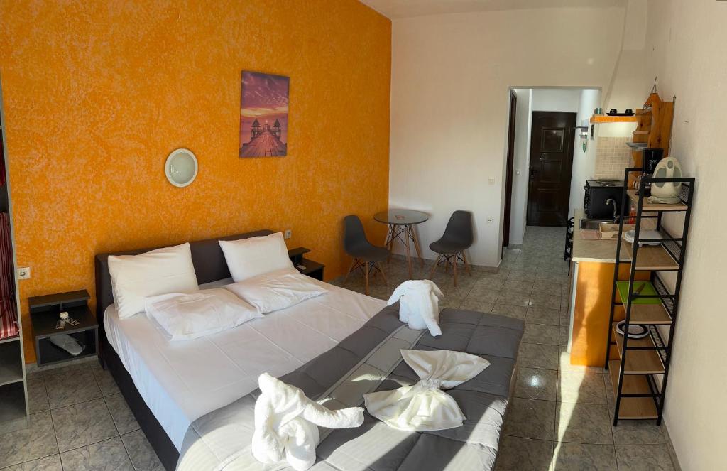 a bedroom with a bed and a table in it at Pelagos Beachfront in Panormos Skopelos