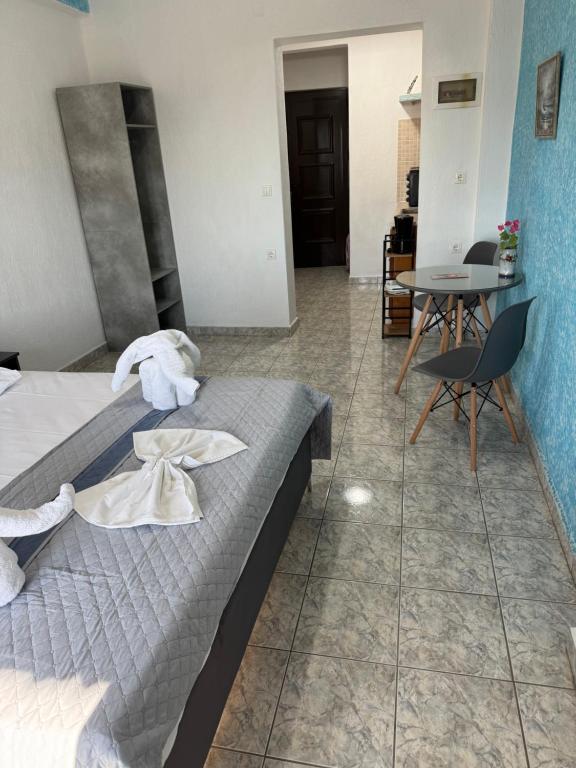 a bedroom with a bed and a table and chairs at Pelagos Beachfront in Panormos Skopelos