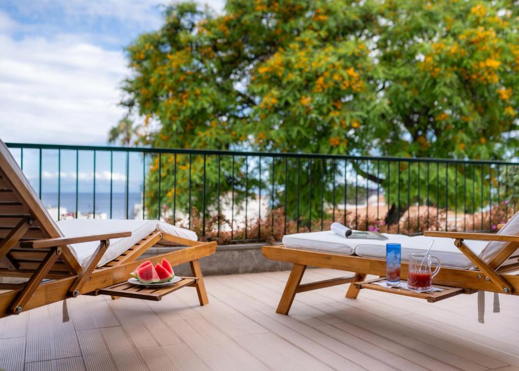 フンシャルにあるMadeira Precious Family Apartmentのバルコニー(ベッド1台、デッキチェア付)