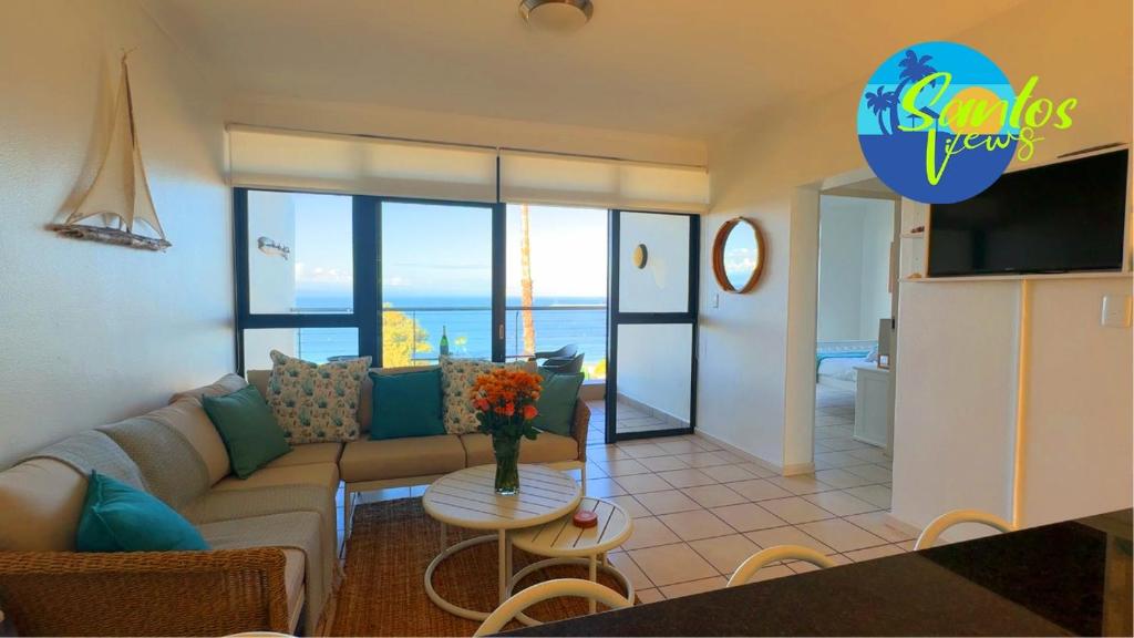 a living room with a couch and a table at Santos View 40 in Mossel Bay