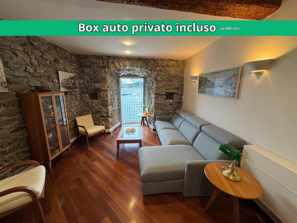 a living room with a couch and a table at Finestra sul Mare di Maury in Portovenere