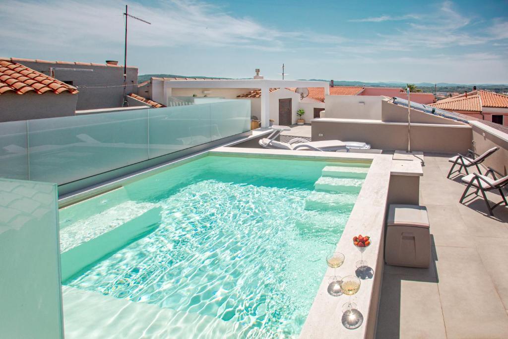 a swimming pool on the roof of a house at Aquarius Deluxe Apartments in Santa Teresa Gallura