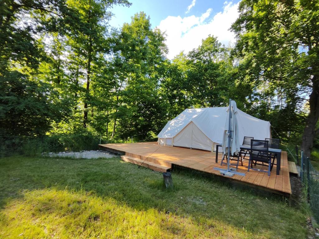 a tent with chairs and a wooden deck at Kleine Freiheit 6- Waldlichtung in Reichendorf