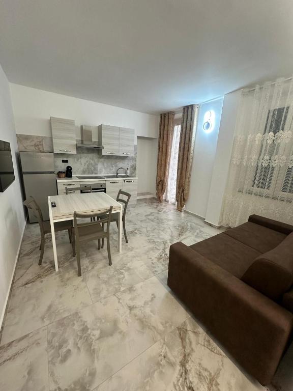 a living room with a couch and a table at SOGNi DOLCI in Vado Ligure