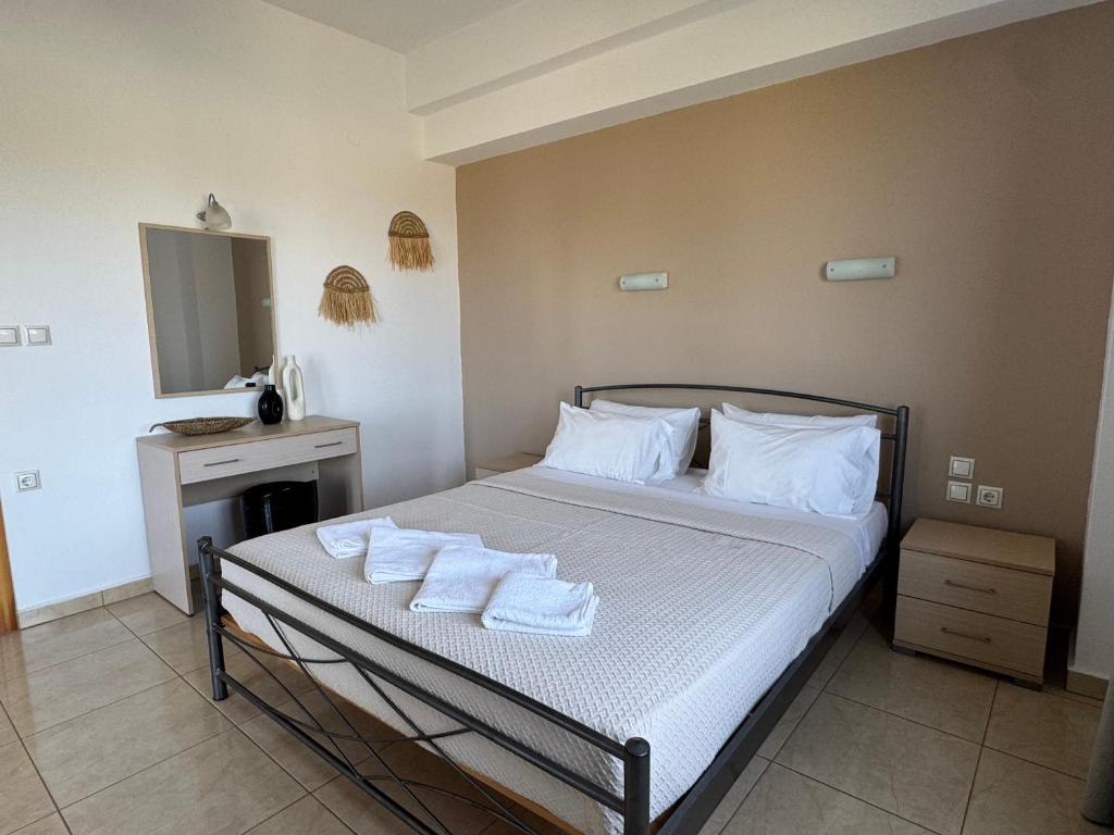 a bedroom with a bed with towels on it at Pachia Ammos Falasarna in Falasarna