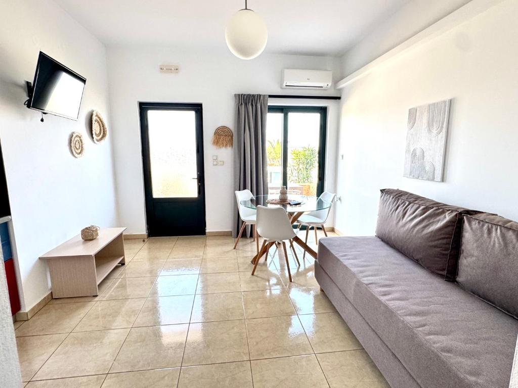 a living room with a couch and a table at Pachia Ammos Falasarna in Falasarna