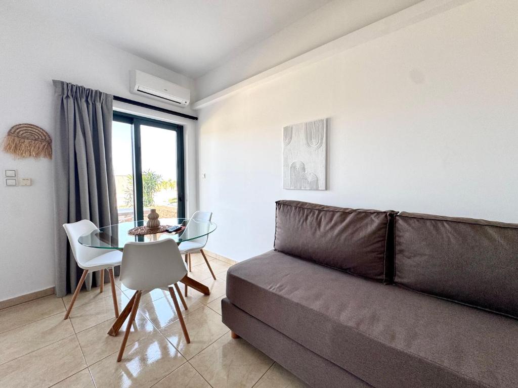 a living room with a couch and a table at Pachia Ammos Falasarna in Falasarna