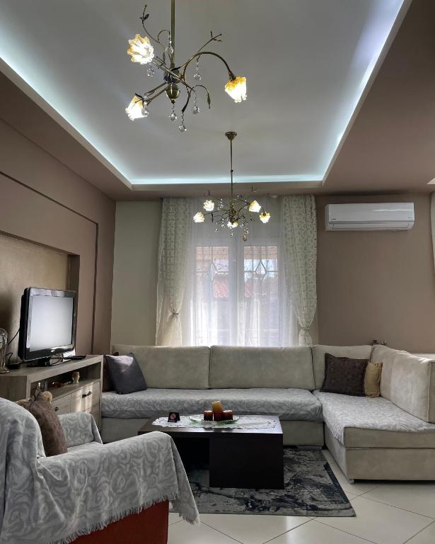 a living room with a couch and a tv at Alba House in Prinos