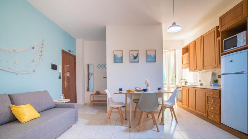 a kitchen and a living room with a couch and a table at 006B - Casa Mare Blu, CENTRO di Riva Trigoso e 300m dalla SPIAGGIA in Riva Trigoso